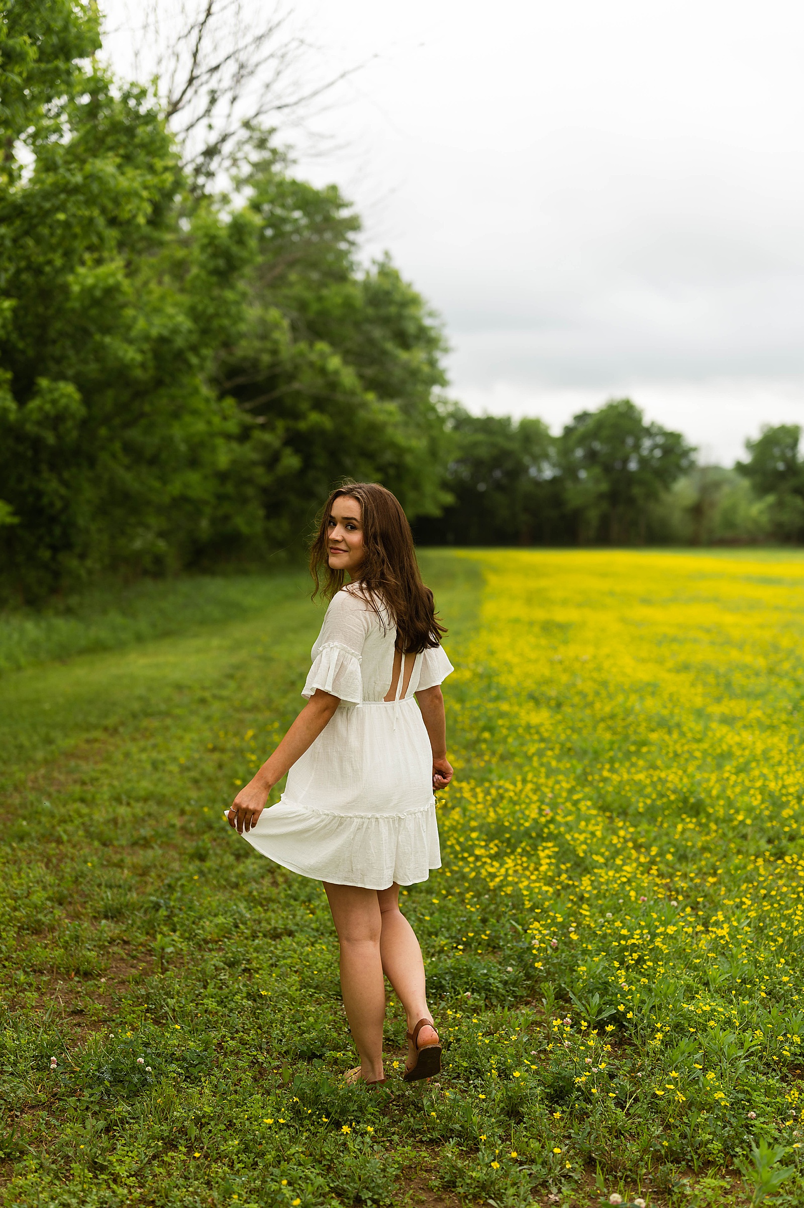 Brunette in white dress in field by Hannah Louise Photography 