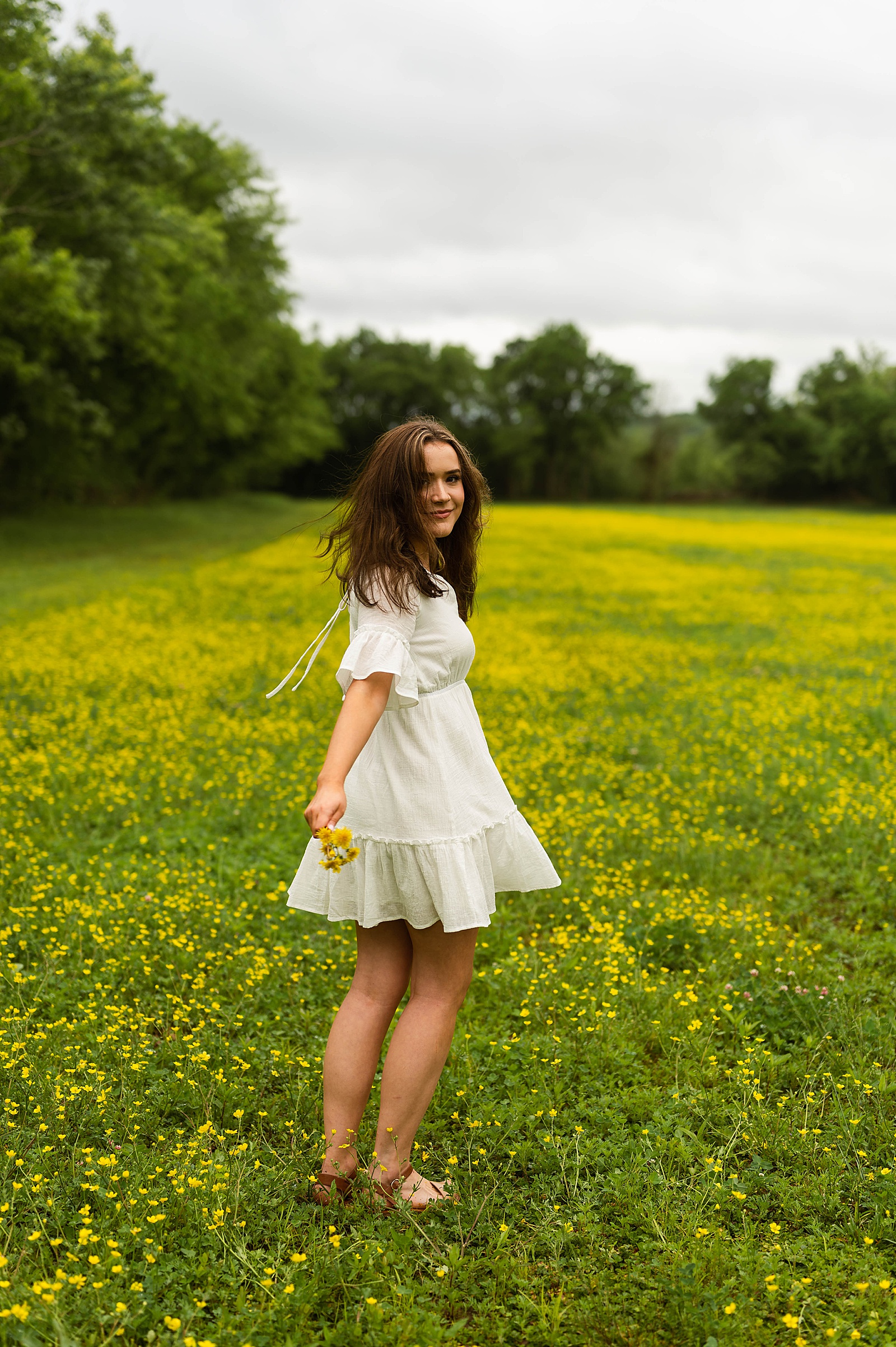 Brunette in short Summer dress in yellow flowers by Richmond Senior photographer 