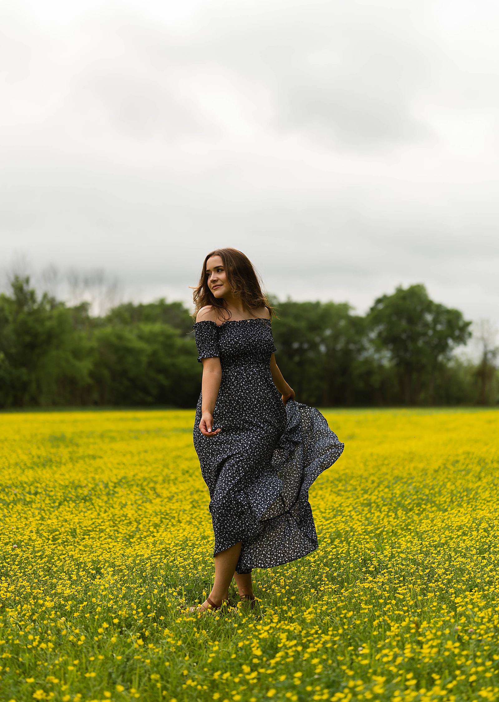 Woman dancing in a yellow field by Hannah Louise Photography 