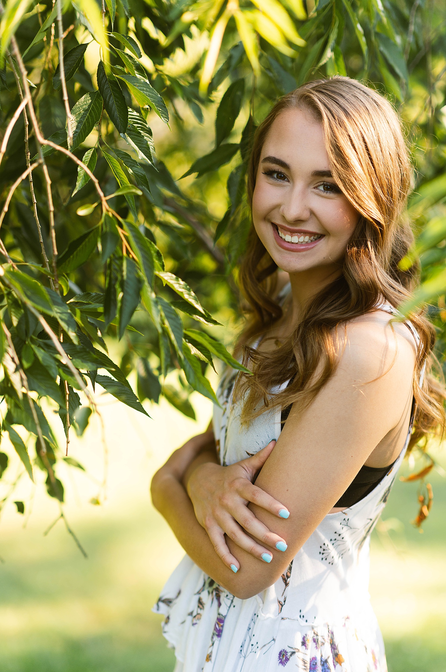 Girl in floral top by a tree for photo shoot with Richmond Senior Photographer