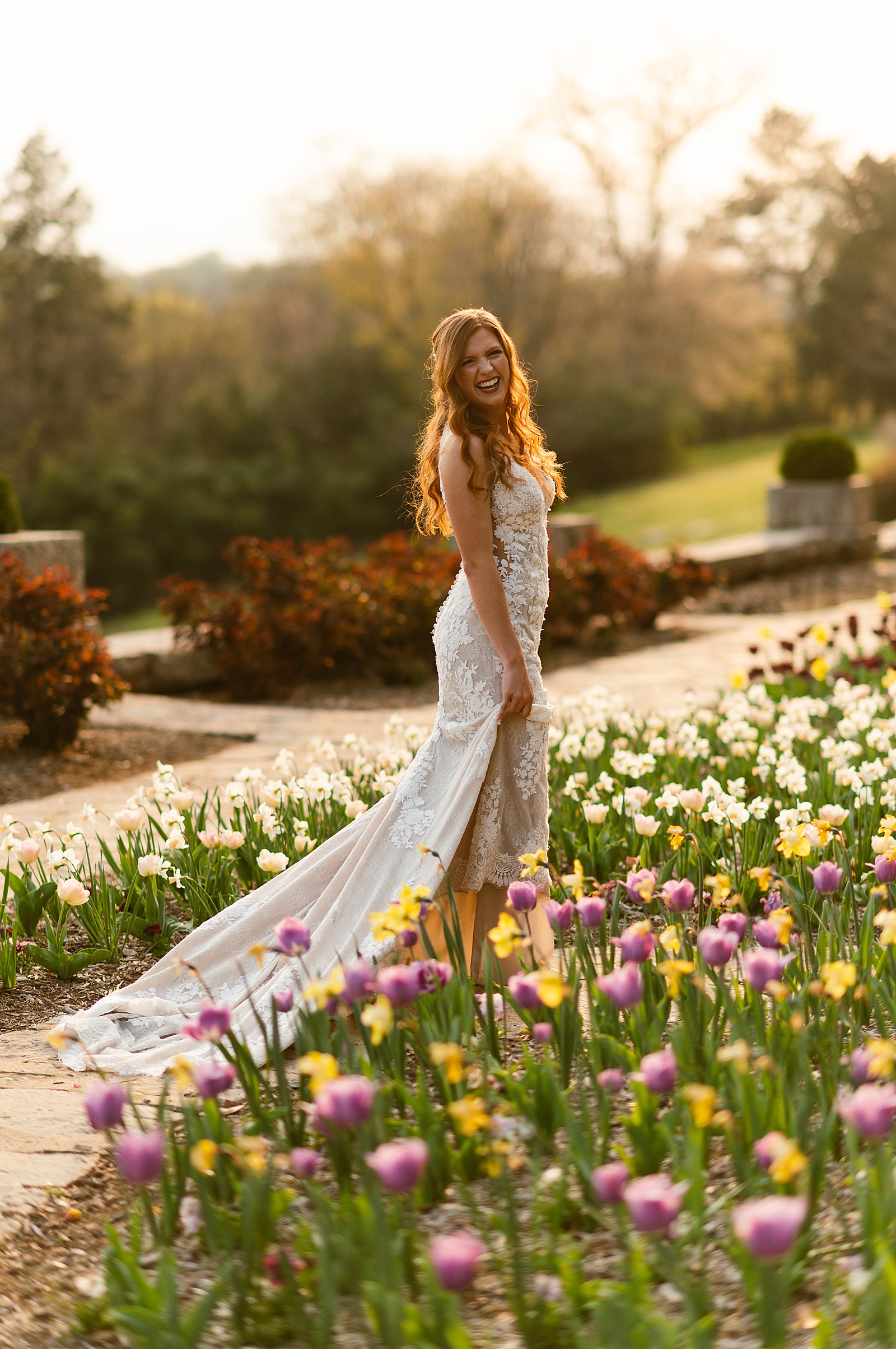woman in white dress dancing in tulips by Hannah Louise Photo
