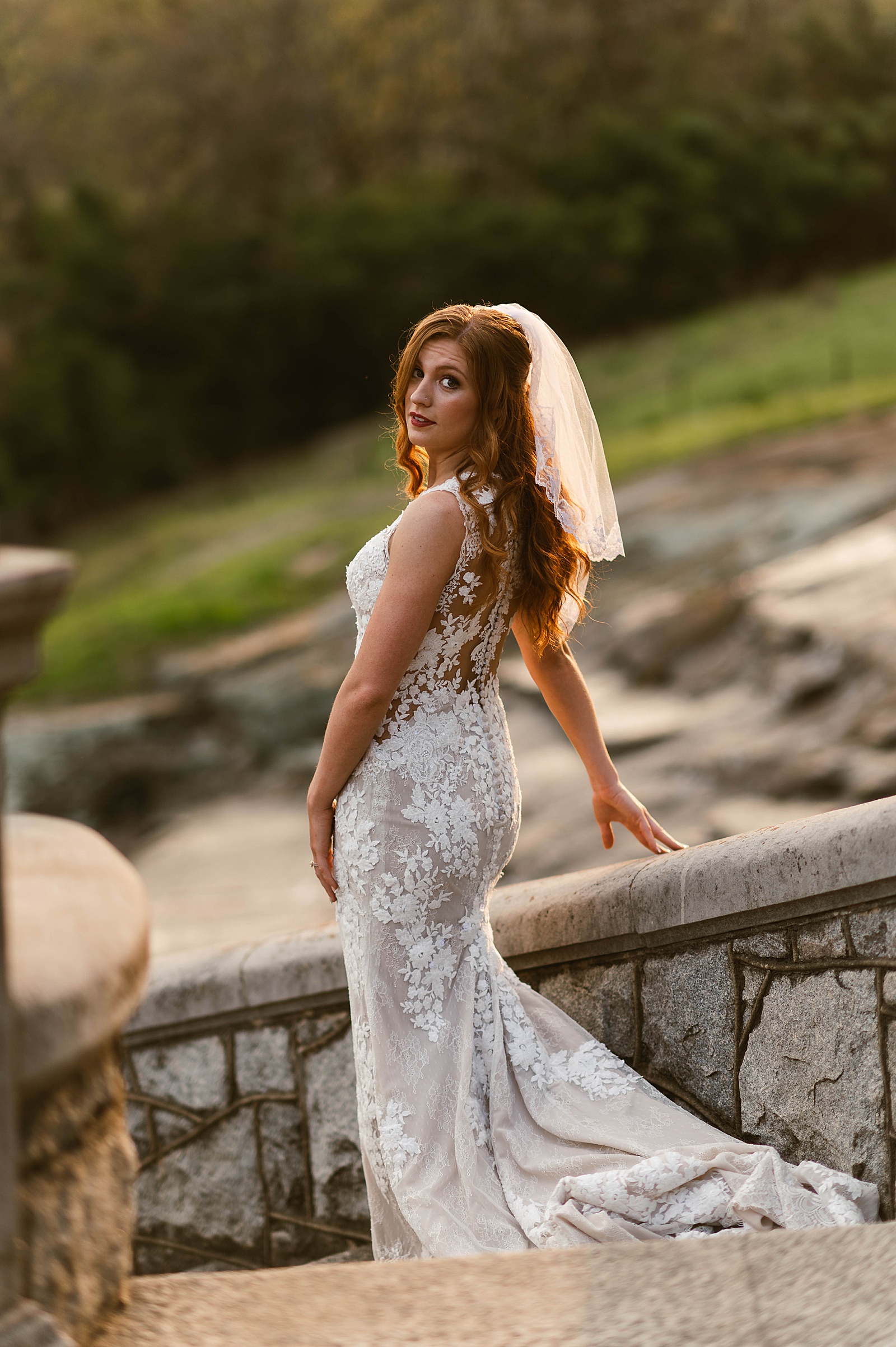Redhead in lace gown walking down stairs for Spring Bridals