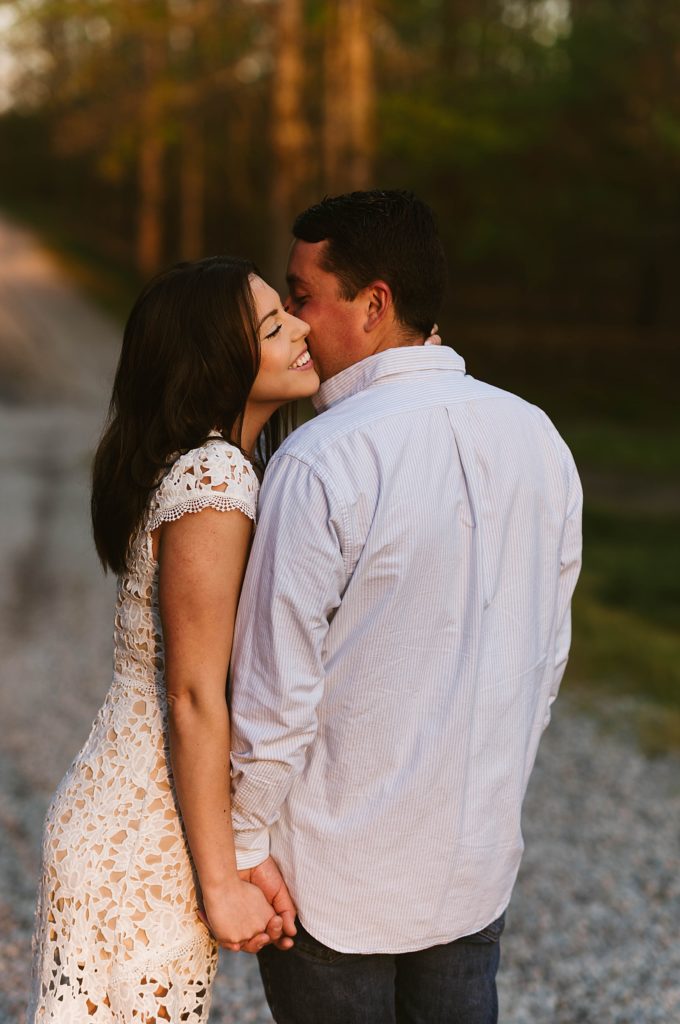 Man kissing fiancé's cheek at photo shoot with Richmond Engagement Photographer 