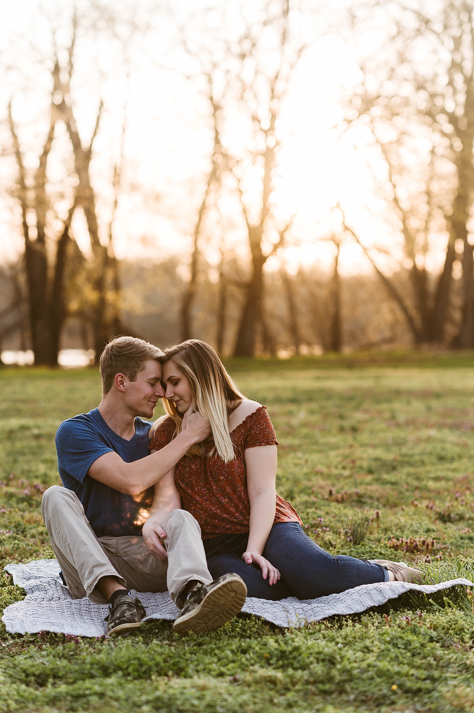 Couple embracing on picnic blanket by Richmond Portrait Photographer