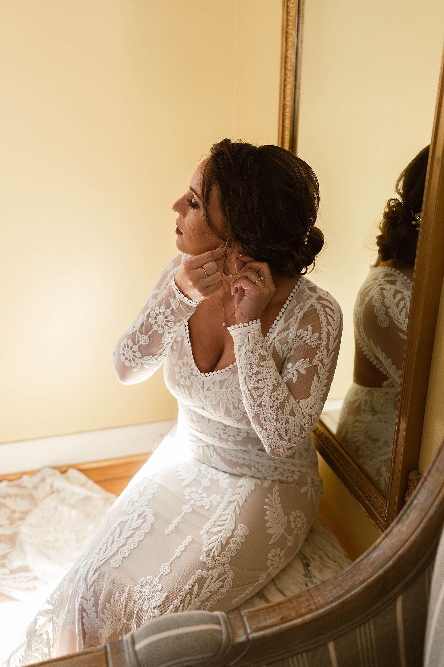 Bride putting on her earring for big day at Amber Grove Venue
