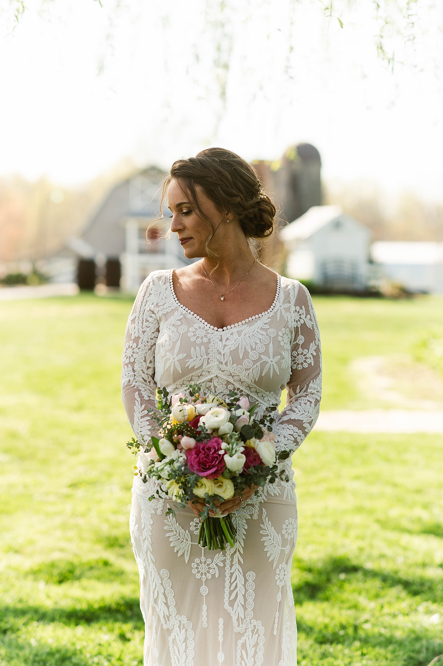 Bride in lace dress with braided updo by Hannah Louise Photo