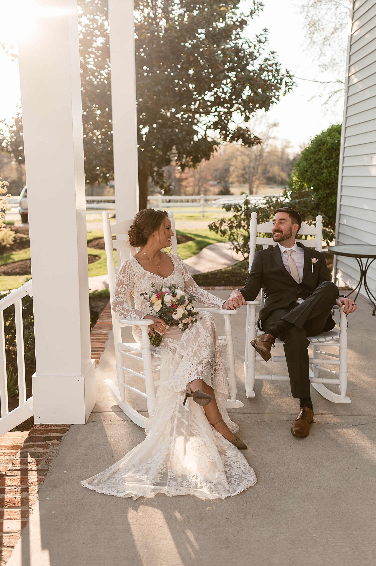 Bride and groom sitting on old rocking chair by Hannah Louise Photo