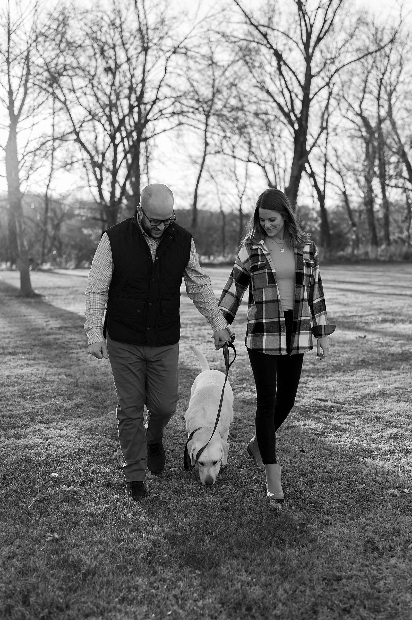 Couple and their dog walking in the park by Richmond portrait photographer
