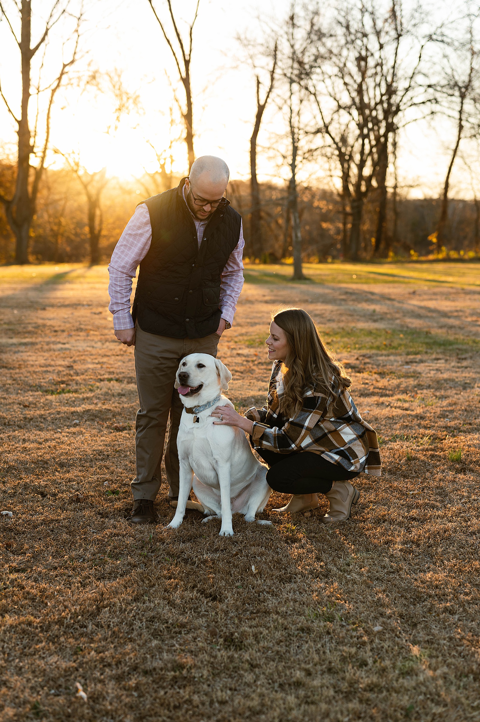 Woman playing with blonde lab for holiday photos 