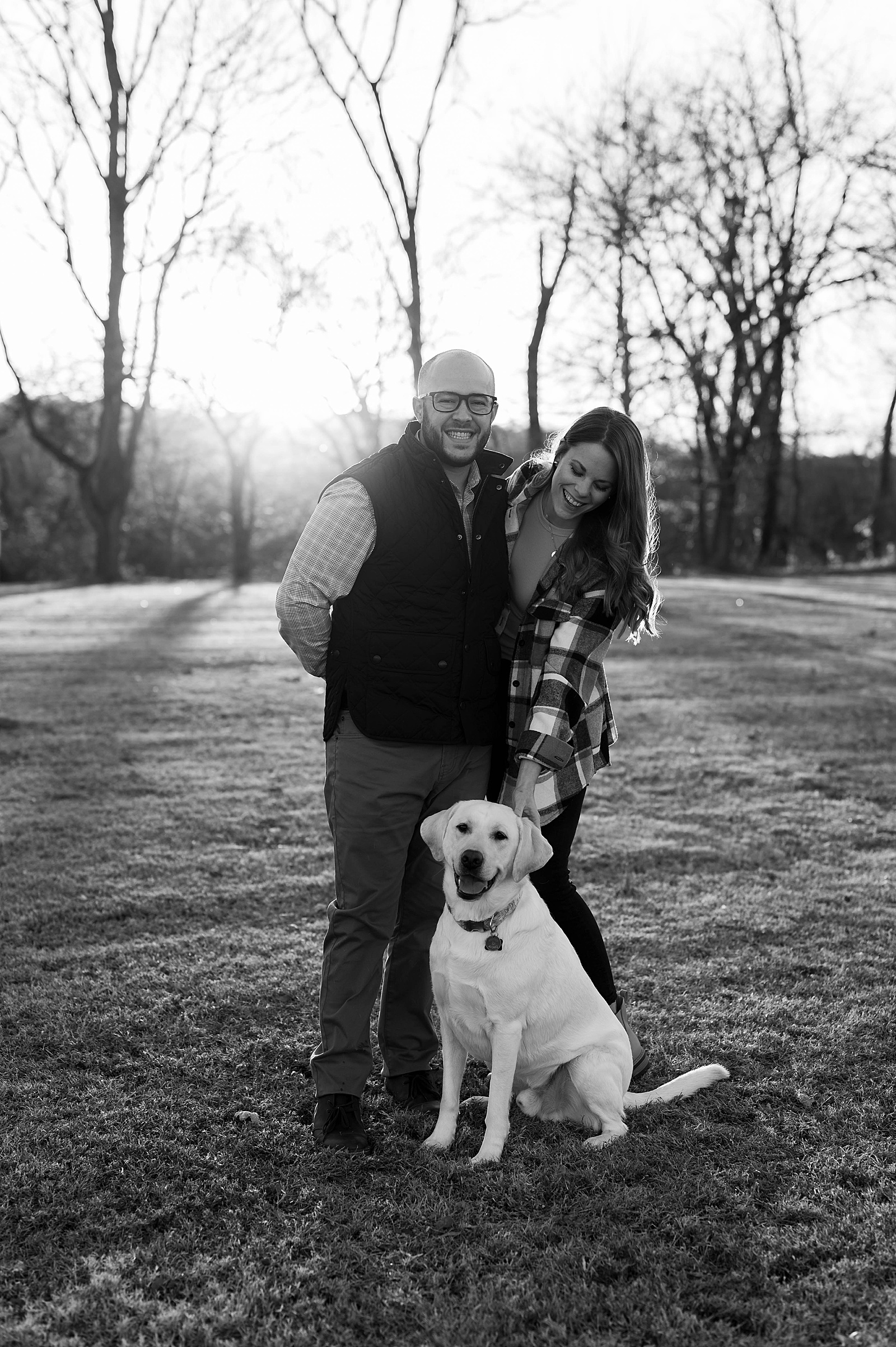 Husband and wife petting dog during golden hour by Hannah Louise photo