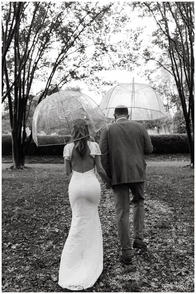 bride and groom walking in the rain by Virginia photographer