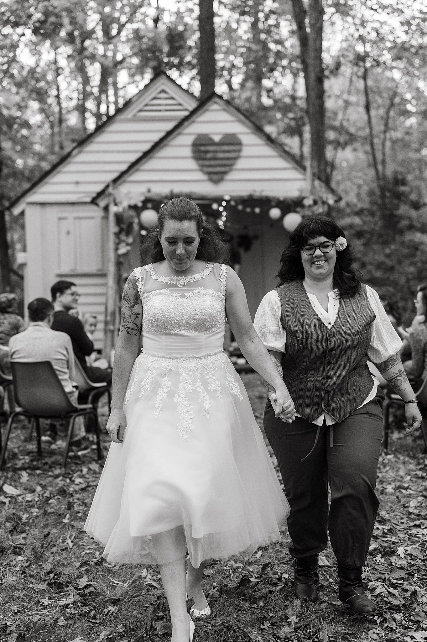 couple walks down aisle together by Hannah Louise Photography