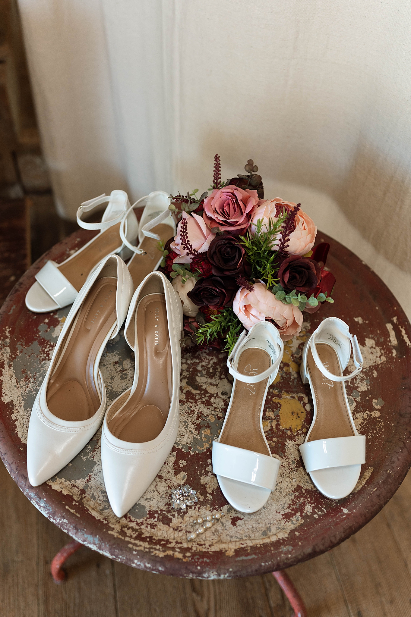 white shoes and colorful bouquet sit on table by Virginia Photographer